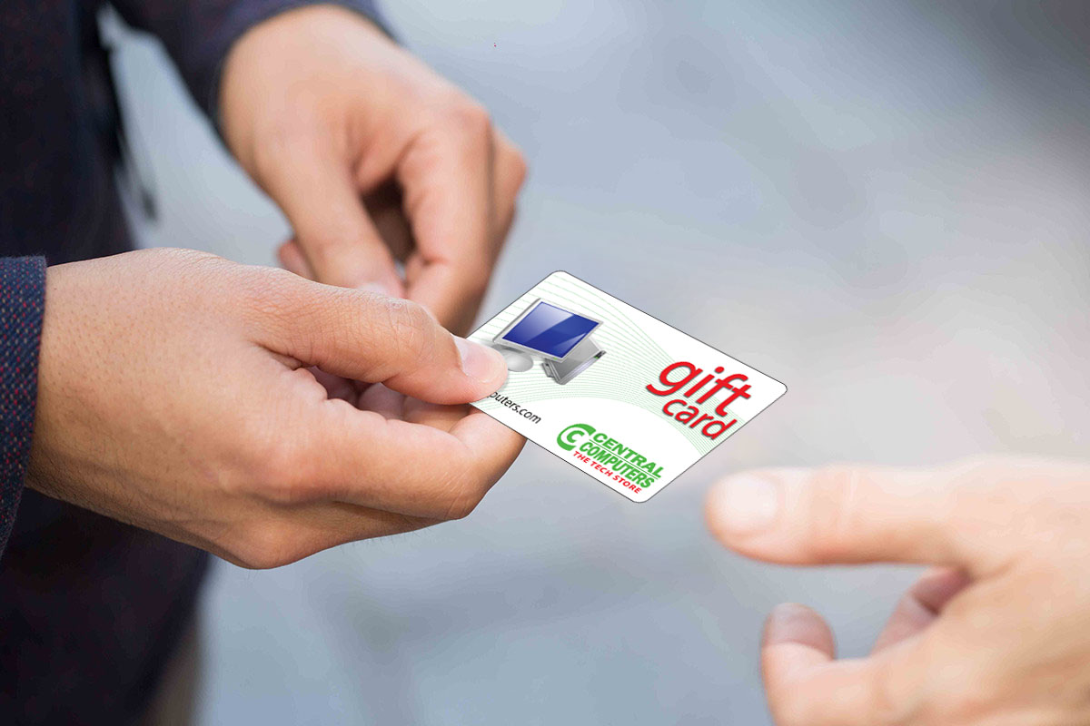 Image of a person handing a Central Computer gift card to another.